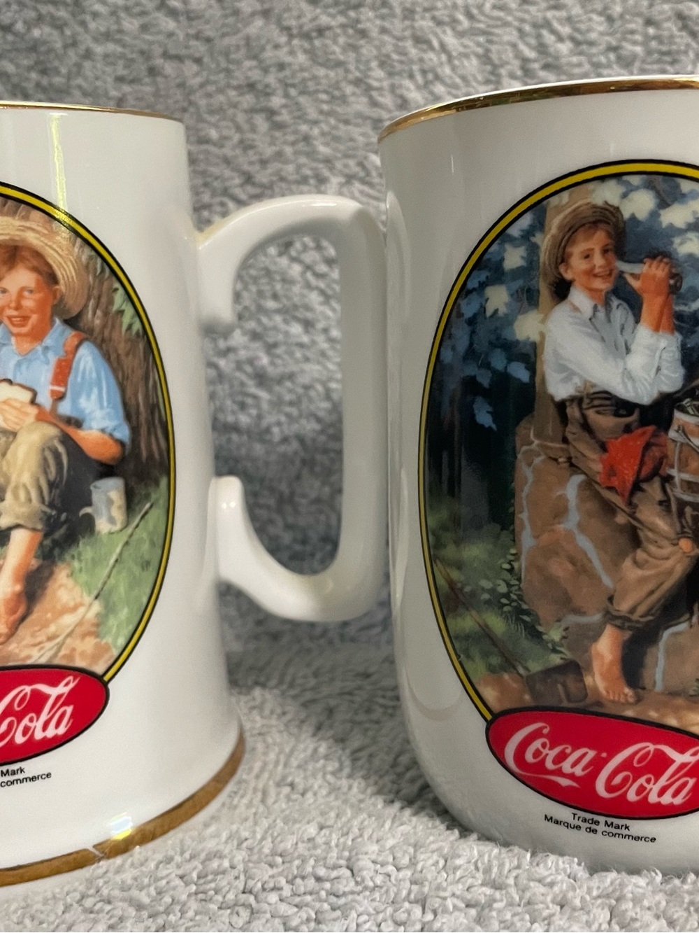 Two Coca Cola White Ceramic Mugs with Gold Trim Vintage Illustrations